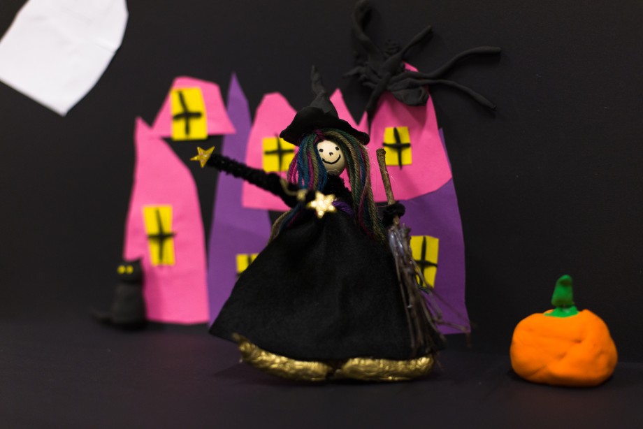 A picture of a witch, a pumpkin and a castle 